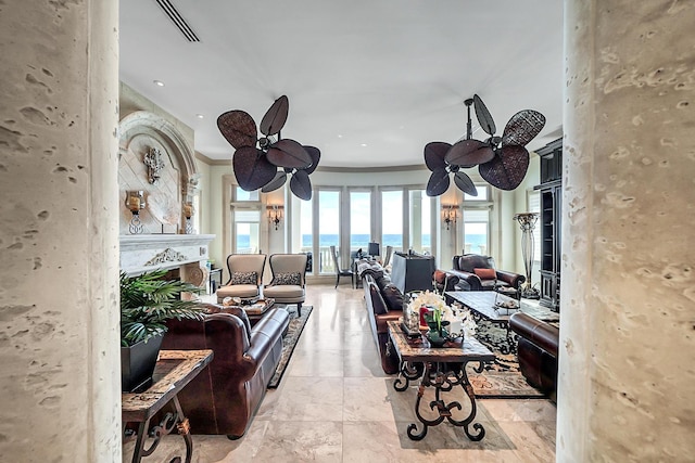 living room featuring crown molding and a water view