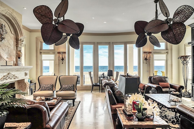 living room with a water view, ceiling fan, and ornamental molding