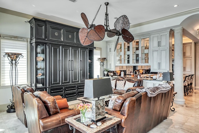 living room featuring ornamental molding and ornate columns
