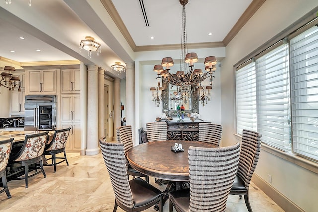 dining area featuring decorative columns, crown molding, and an inviting chandelier