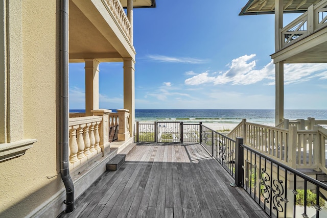 deck with a water view and a view of the beach