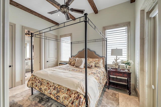 bedroom with ceiling fan and beam ceiling