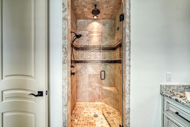 bathroom featuring vanity and a shower with door