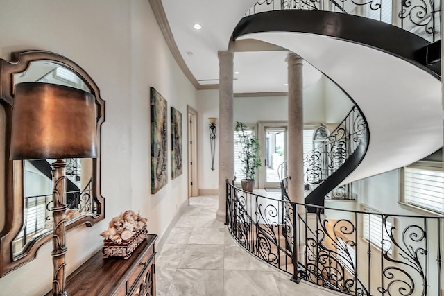 corridor with decorative columns and ornamental molding