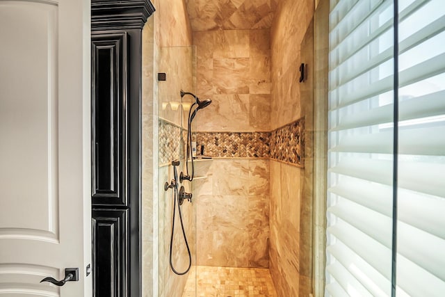 bathroom with a tile shower
