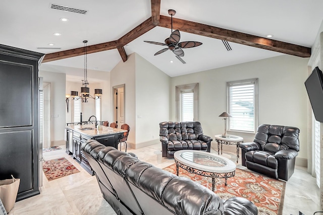 living room featuring lofted ceiling with beams, sink, and ceiling fan with notable chandelier