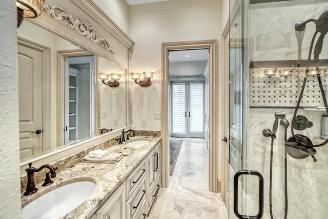 bathroom with vanity and a shower with door
