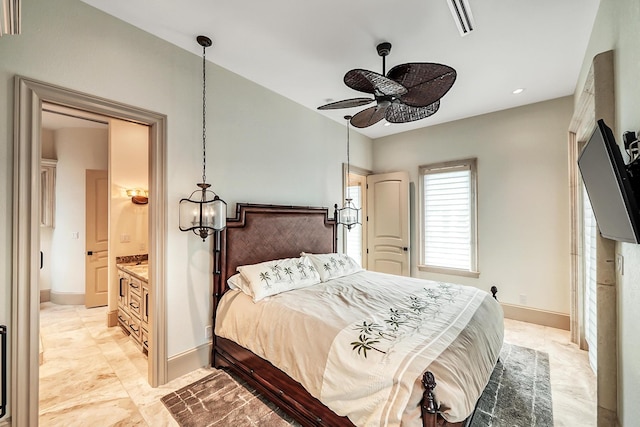 bedroom featuring ceiling fan and connected bathroom