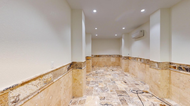 spare room with a wall mounted air conditioner and tile walls