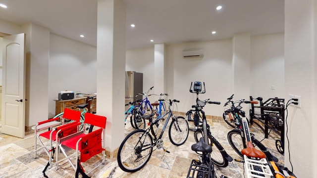 garage with stainless steel fridge and a wall unit AC