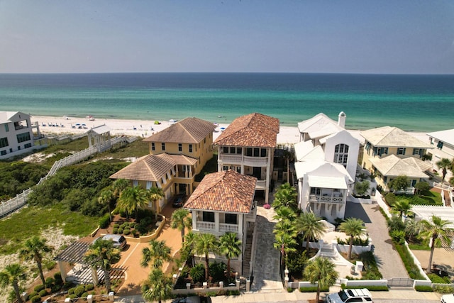 bird's eye view featuring a water view and a beach view