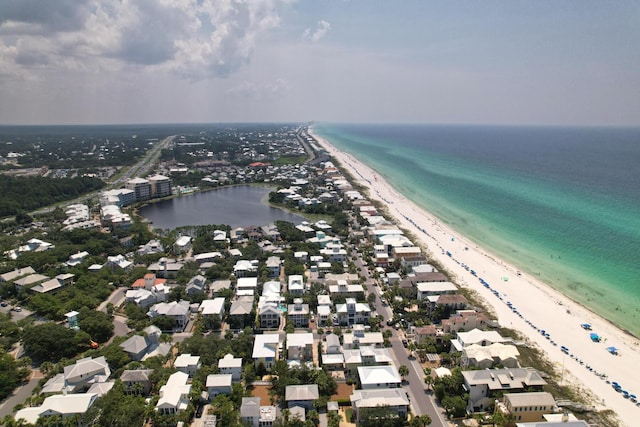 drone / aerial view featuring a water view and a beach view