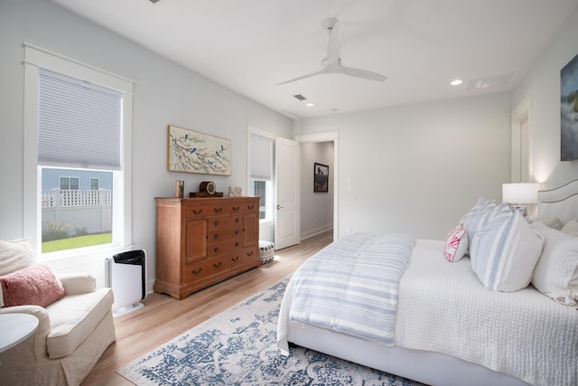 bedroom featuring light wood-type flooring, visible vents, a ceiling fan, recessed lighting, and baseboards