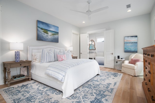 bedroom with visible vents, recessed lighting, ensuite bath, and wood finished floors