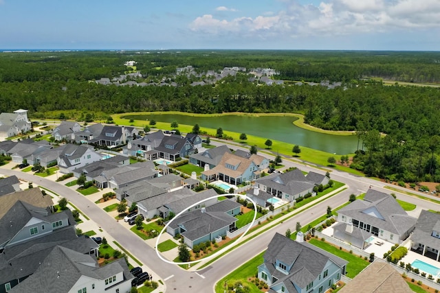 aerial view featuring a residential view, a water view, and a wooded view