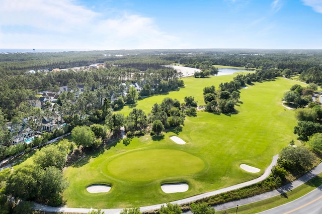 drone / aerial view with a water view and view of golf course