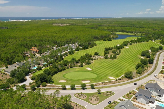 aerial view with a view of trees, a water view, and view of golf course