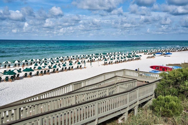 birds eye view of property with a beach view and a water view