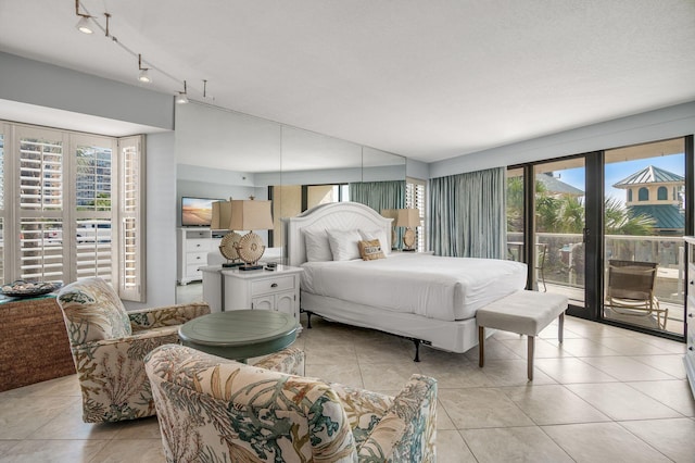 tiled bedroom featuring access to outside