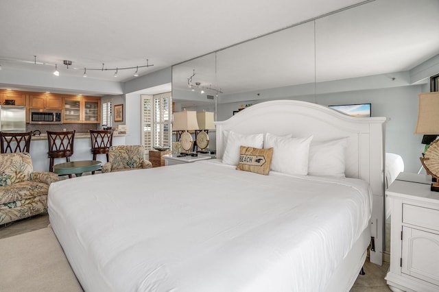 bedroom featuring stainless steel fridge