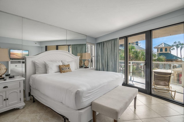 bedroom featuring access to exterior and light tile patterned floors