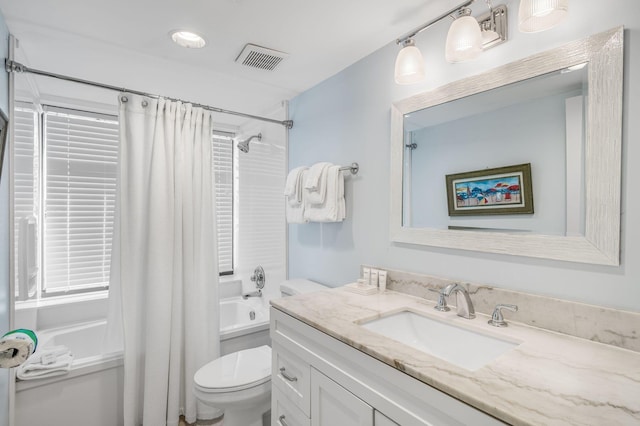 full bathroom with vanity, shower / bath combo, and toilet