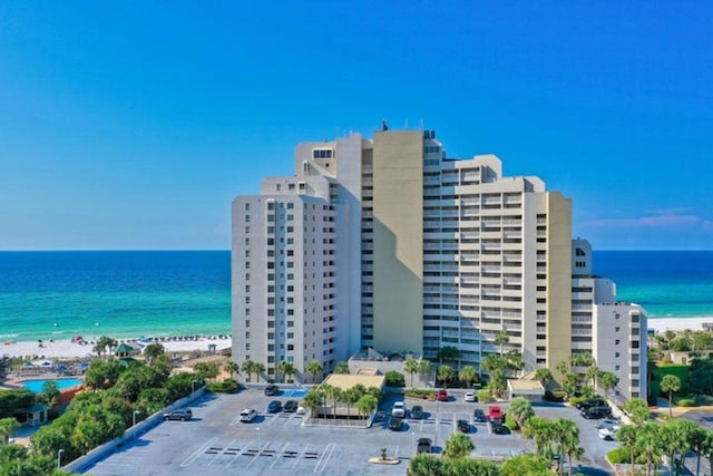 exterior space featuring a water view and a beach view