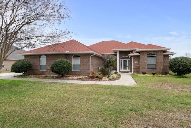 ranch-style home featuring french doors and a front yard