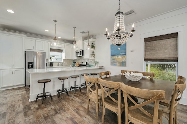 139 Brown St, Santa Rosa Beach, FL 32459 - dining room with dark wood-type flooring and crown molding