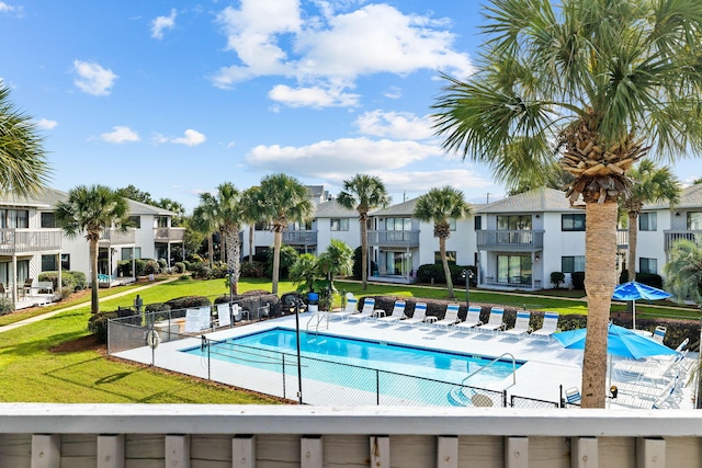 view of swimming pool featuring a yard and a patio