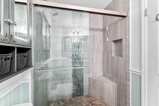 bathroom with an enclosed shower and a textured ceiling