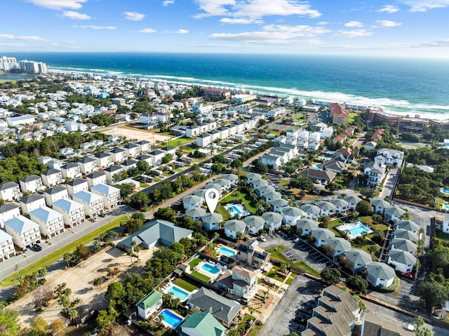 birds eye view of property with a water view and a view of the beach