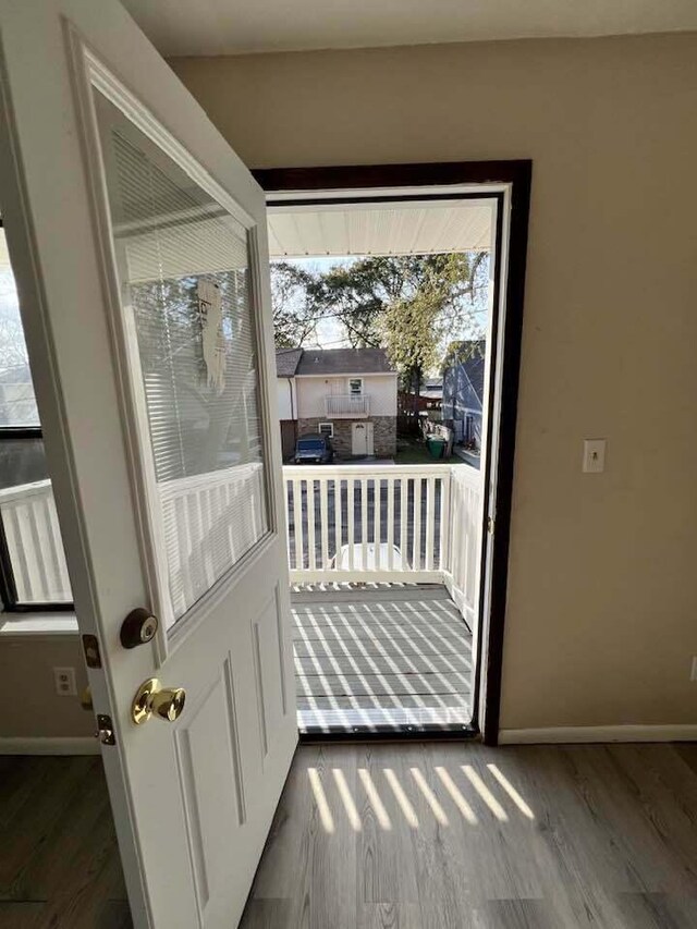 entryway with wood finished floors and baseboards