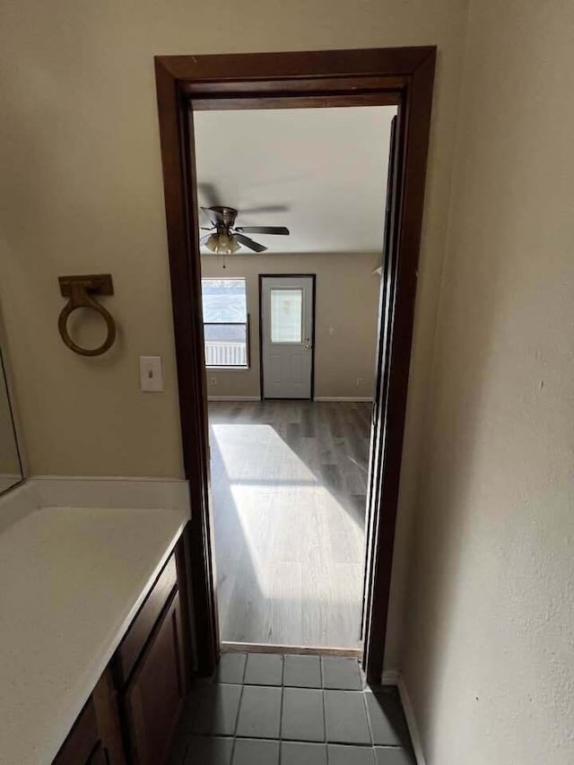 bathroom featuring tile patterned flooring, baseboards, and a ceiling fan