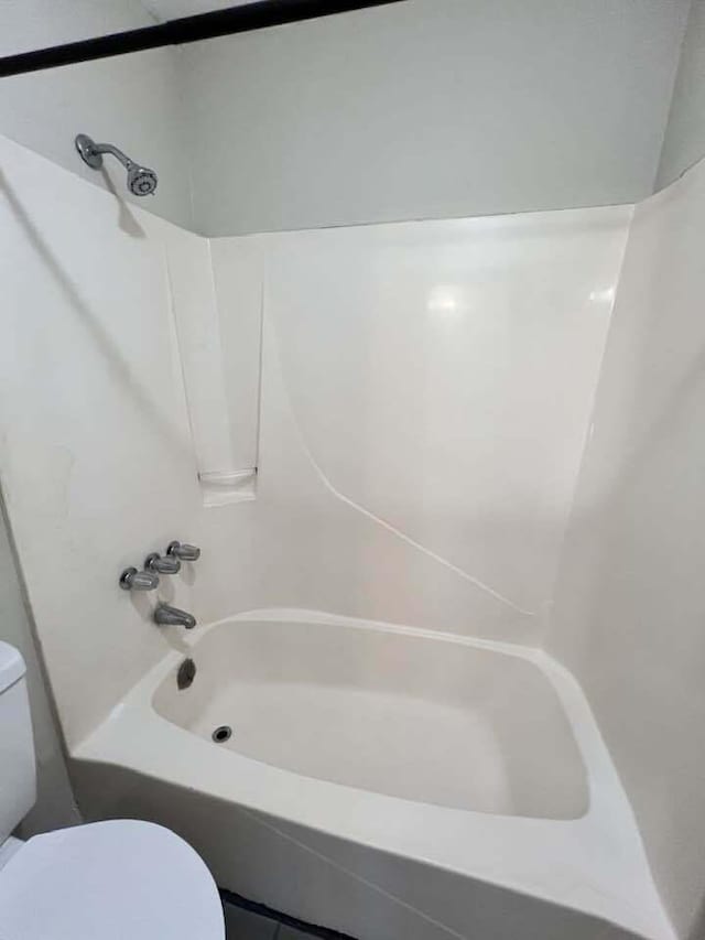 full bathroom featuring shower / tub combination and toilet