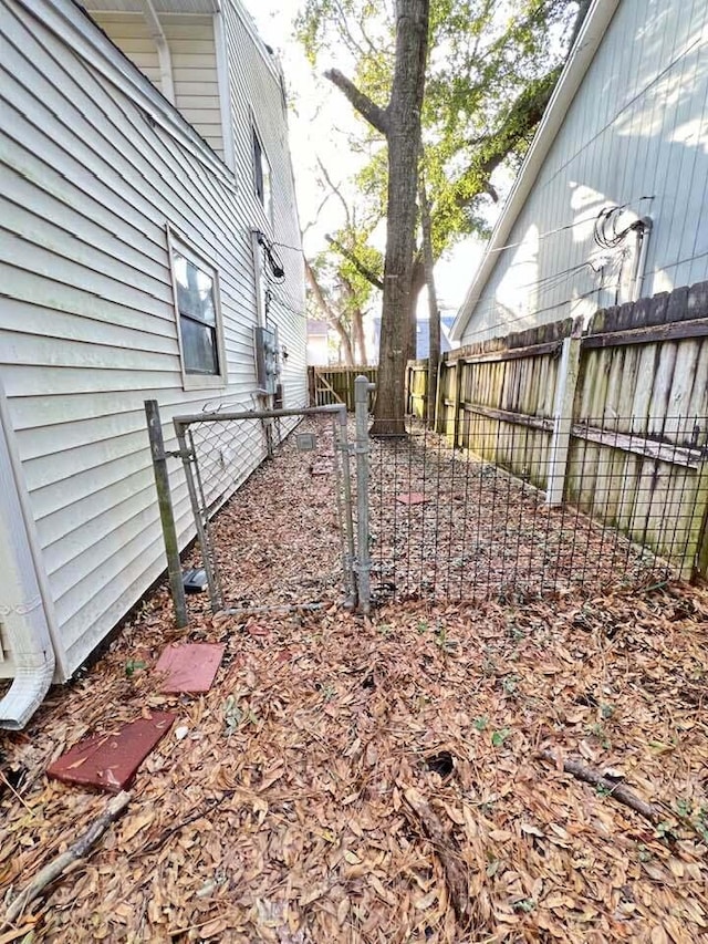 view of yard featuring a fenced backyard and a gate