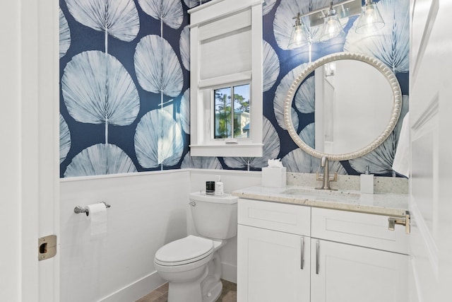 bathroom featuring vanity and toilet