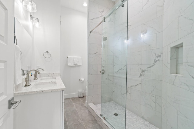 bathroom featuring a shower with door and vanity