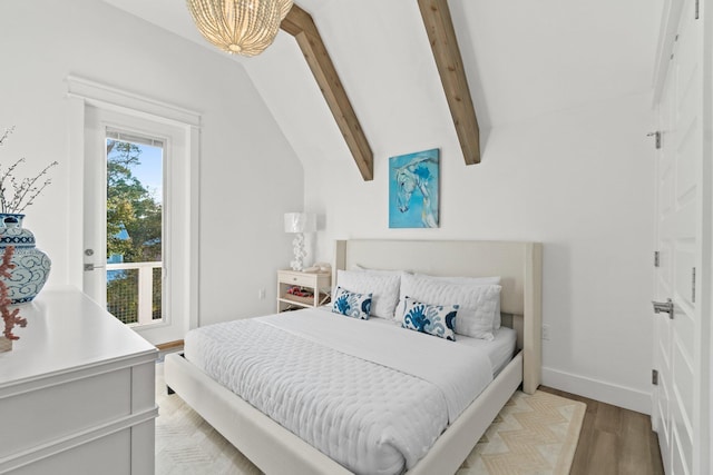 bedroom with vaulted ceiling with beams and light hardwood / wood-style floors