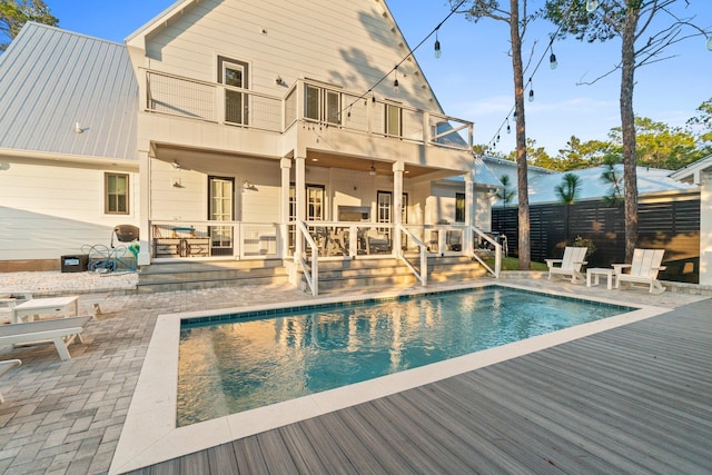 view of pool with ceiling fan and a patio area