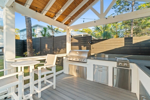 deck with area for grilling and an outdoor kitchen