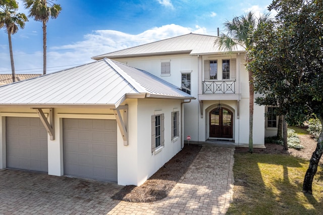 view of front of house with a garage and a balcony