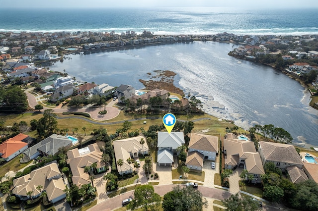 birds eye view of property with a water view