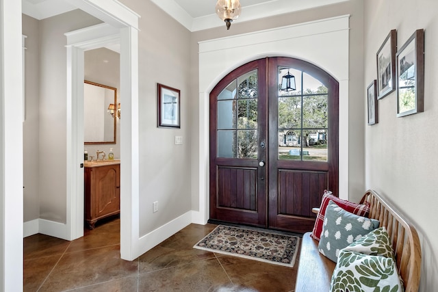 tiled foyer with sink and french doors