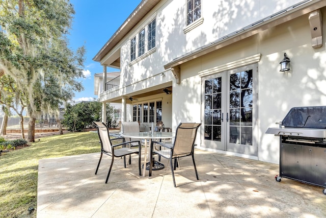 view of patio with french doors, ceiling fan, grilling area, and a balcony