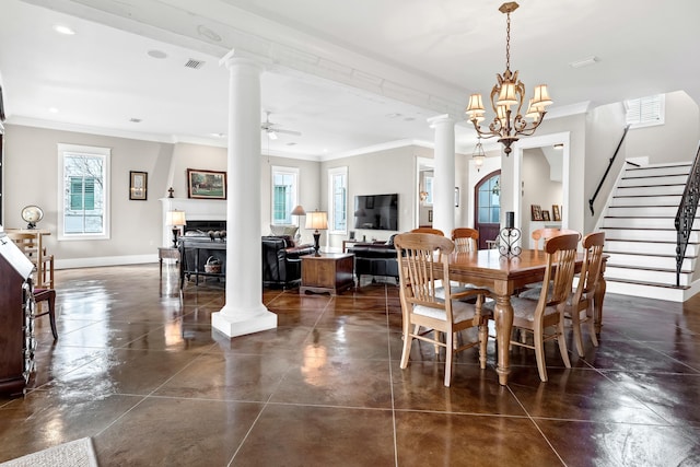 dining room with decorative columns, crown molding, and ceiling fan with notable chandelier