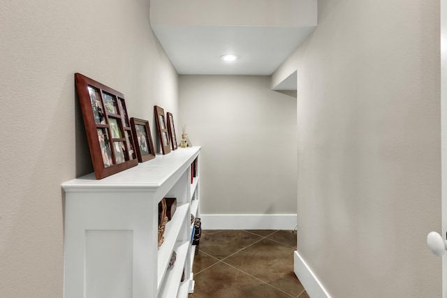 corridor featuring dark tile patterned flooring