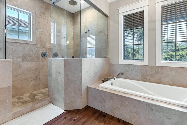 bathroom featuring hardwood / wood-style flooring and shower with separate bathtub