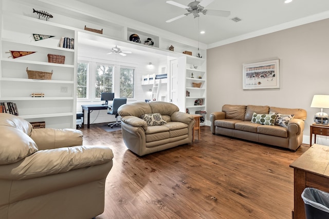 living room featuring wood-type flooring, ornamental molding, built in features, and ceiling fan