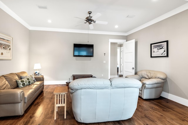 living room with crown molding, ceiling fan, and dark hardwood / wood-style flooring